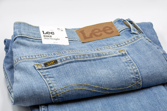 Lee Rider slim straight jeans folded on white background closeup.