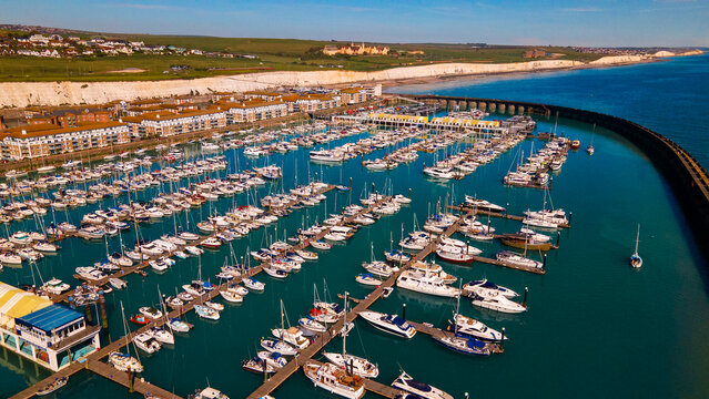 High aerial perspective of recreational yachts moored in a protected harbor
