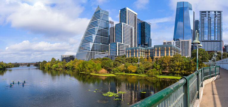 City at Shore - Morning Sun shines on modern skyscrapers towering at shore of Lady Bird Lake, as seen from South First Street Bridge, Downtown Austin, Texas, USA.