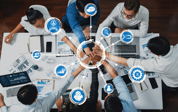 Top view diverse office worker join hand together in office room symbolize business synergy and strong productive teamwork in workplace. Cooperation and unity between business employee. Prudent Amity