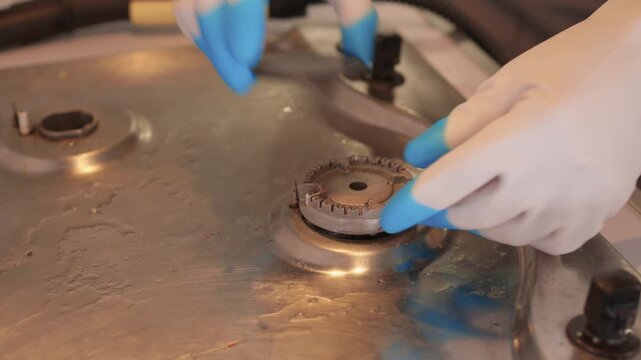 Professional technician ensures proper cleaning and safety measures. Trained technician performs detailed cleaning while maintaining safety in modern kitchen environment