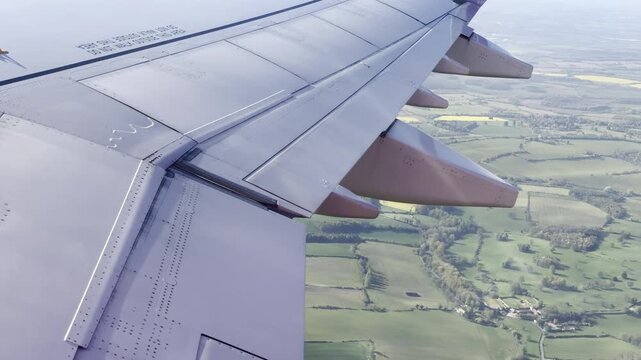 Aircraft arriving over patchwork meadows panning
