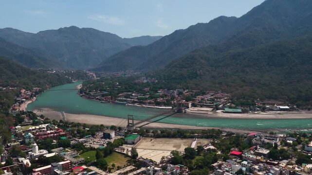 Beautiful Aerial View of Rishikesh Showing Bridges, Houses with Ganga River and Mountains