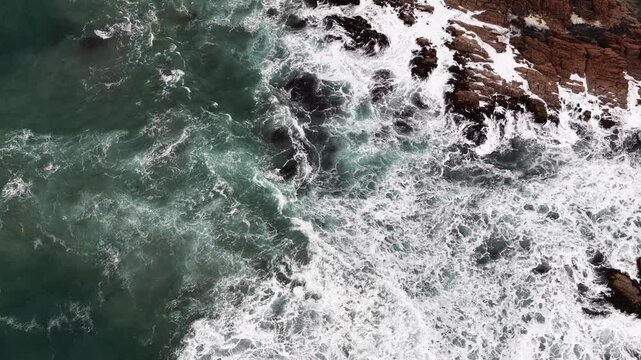 Lift from rugged wild terrain of Tasmania West Coast in aerial view to Bluff Hill point lighthouse.