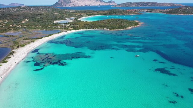 Spiaggia di Lu Impostu 4K Aerial View of Cala Brandinchi SARDINIA  , Lu Impostu Bays. Cinematic aerial Drone Flight over Little Tahiti Turquoise Sea and White Sand. San Teodoro  top of Sardegena beach