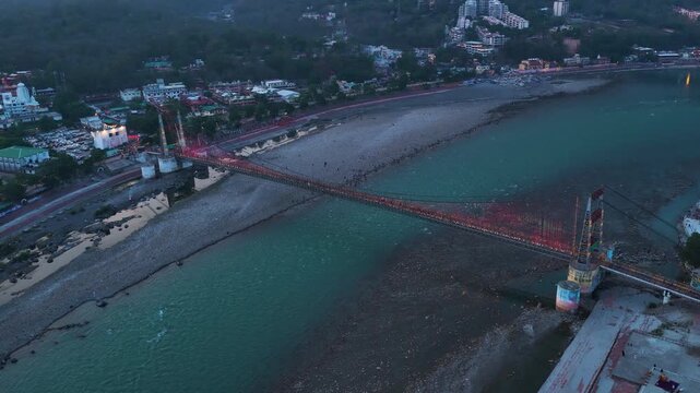 Orbit aerial shot of Janki Setu Bridge at rishikesh night view, 4k footage 