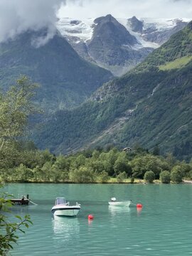 Alpine Lake with Moored Boats and Glacier Mountains in Stryn, Norway