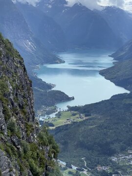 Scenic alpine lake valley with snow-capped mountains in Loen, Norway