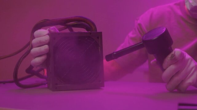 Technician cleaning computer. Expert cleaning and examining computer hardware meticulously. Technician carefully clearing dust from open computer with specialized tools