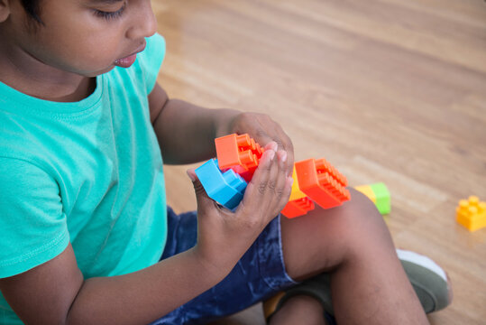 Adorable child engaging in creative play with bright toy blocks. Educational activity that supports motor skills, imagination, and cognitive development in early childhood