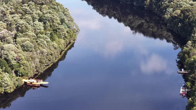 Cable Fatman barge carrying land transport across Pieman river in Tasmania &ndash; aerial.