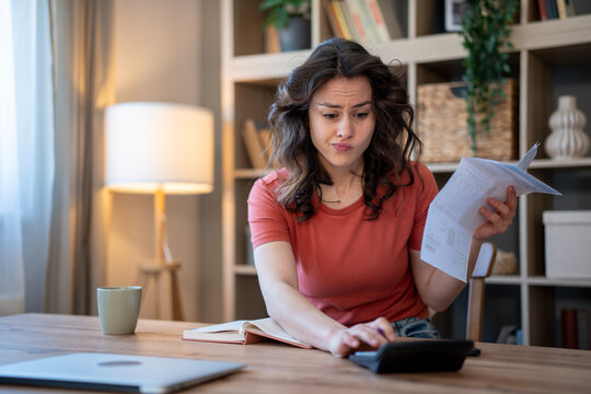 Woman calculating finances, managing bills and budget