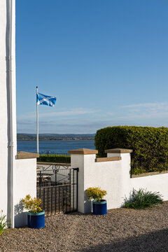 Scottish flag proudly waves above Findhorn Bay on a bright sunny day in Moray Scotland