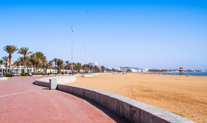Seafront promenade or Corniche and city beach with palm trees in Agadir, Morocco. Popular tourist area with shops and restaurants. Moroccan seaside resort © Julia Lavrinenko