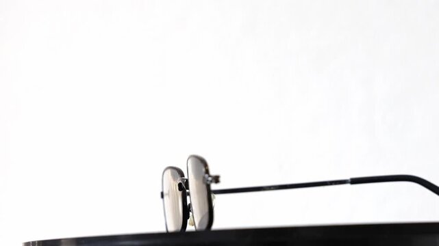 Old broken glasses with missing parts, spinning white background