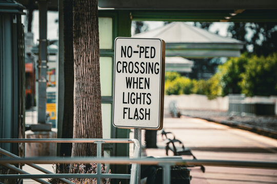 No Pedestrian Crossing When Lights Flash Sign at Train Station Platform