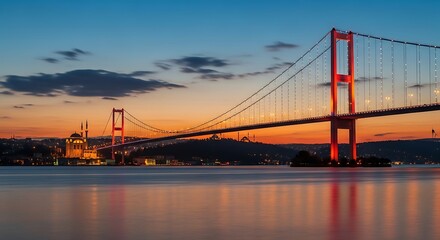 Fototapeta premium Suspension bridge at sunset over calm water and distant buildings