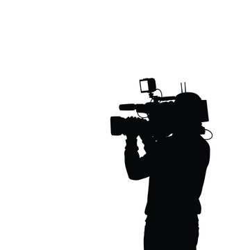 Silhouette of a person operating a professional video camera for film production