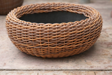 Obraz premium Low round wicker bowl planter for succulents courtyard landscaping accent