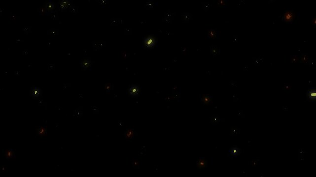Abstract glowing golden and red dust particles rising and floating against a dark background in slow motion movement