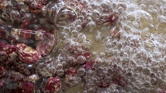 Spring_water_pouring_on_pinto_beans_macro_bubbles_120fps