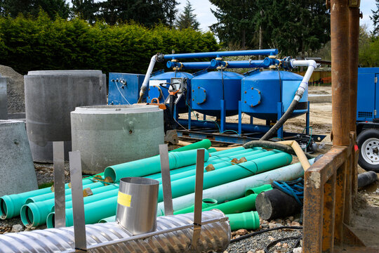 Blue skid-mounted industrial groundwater filtration system, construction site remediation pumping and cleaning excess rain water before sending into municipal system
