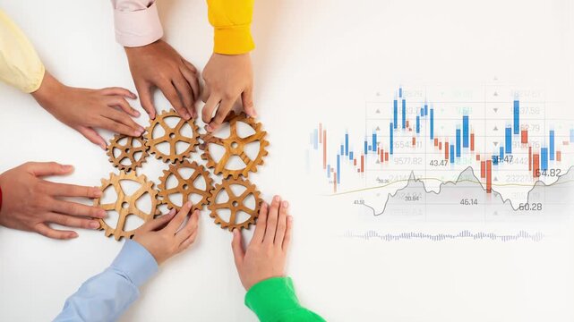 Diverse hands engage in teamwork around wooden gears, symbolizing collaboration and strategy, while stock market data showcases business performance trends and analysis. Raster