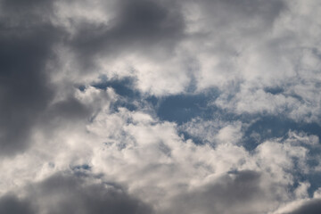 Fototapeta premium Calm clouds in clear sky. Serene bright sky filled with soft clouds and gentle glow. Tranquil midday sky featuring billowy clouds and atmosphere of peacefulness