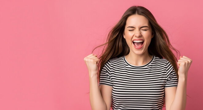 Excited young woman cheering with clenched fists perfect for celebrating business success and future goals