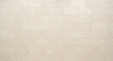 Fototapeta premium Off-white rectangular stone tile wall with subtle speckled texture and horizontal running bond pattern