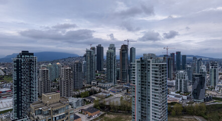 Obraz premium Burnaby City Skyline With High-Rise Towers and Construction Cranes Over Greater Vancouver, British Columbia
