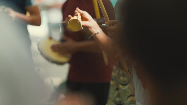 Capoeira musicians playing traditional berimbau instrument