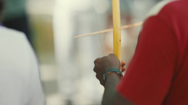Capoeira musician playing traditional berimbau instrument