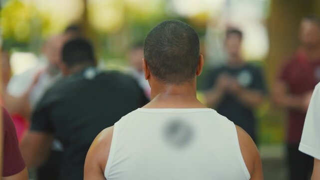 Back of a man watching a group of people