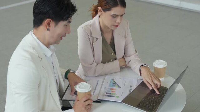 Business marketing strategy model ai teamwork analysis meeting guide in modern office review as two coworkers discuss data at laptop with coffee, refine plan for growth, calm focus on campaign goal