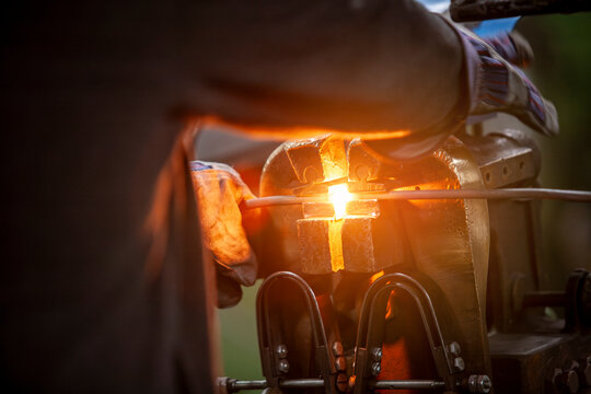laborer manipulating metal with heat