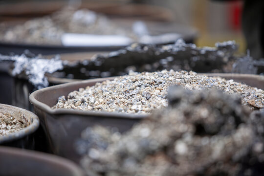 barrels of raw metal granulate
