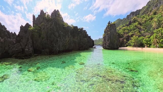 Hidden Beach on Matinloc Island, Palawan, Philippines, reveals clear turquoise water surrounded by towering limestone karsts, creating a secluded tropical lagoon in Philippines