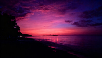 Obraz premium Vibrant Purple and Pink Dramatic Sunset Over the Ocean