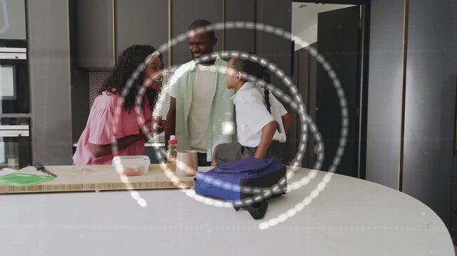 Mother initiating spiral overlay as parents packing blue lunch bag, preparing child for school