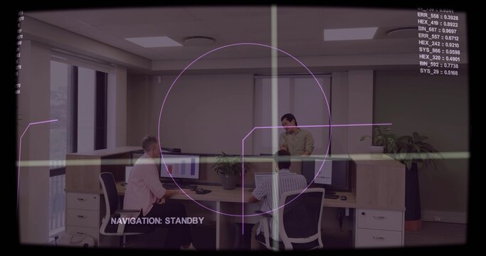 Leaning colleague addressing seated coworkers in pink blazer at office desk cluster, HUD overlay