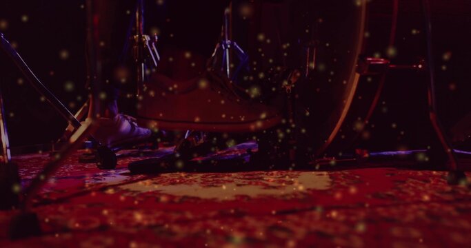 Playing drummer's foot pressing kick pedal on stage rug, showing sneaker and dark pants, bass drum