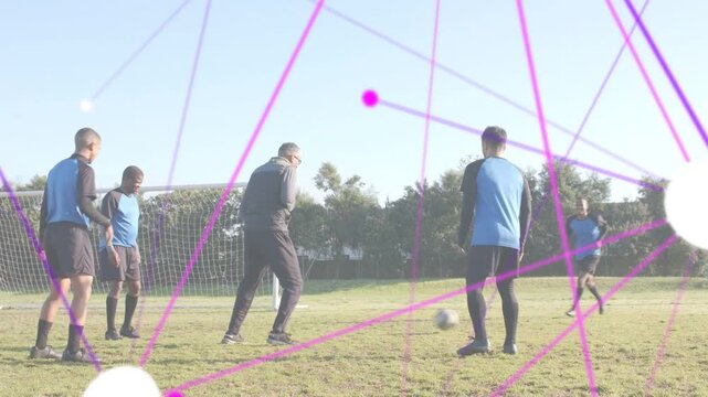 Coach speaking, gesturing, team passing in soccer drill near mini goal, magenta overlay crossing