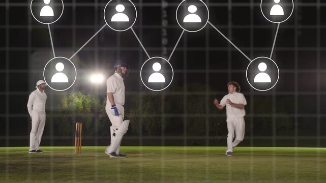 Bowler running and bowling batsman watching fielder lunging under expanding binary net for wicket