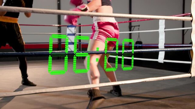 Two boxers in ring training, pink fighter advancing, falling, rising, green timer counting down