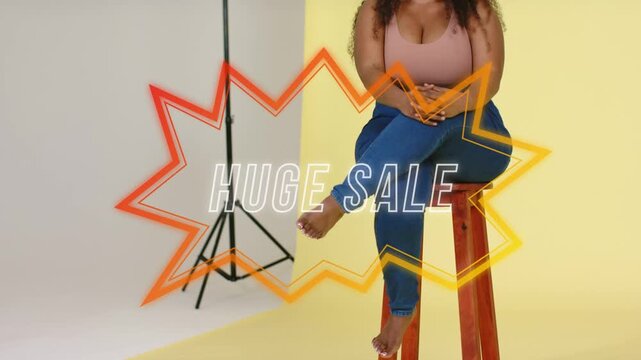 Animated starburst appearing over lap, model on stool moving limbs as camera pulling back HUGE SALE