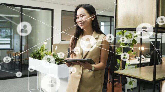 Office woman tapping tablet and generating network graphics, visualizing tech network while smiling