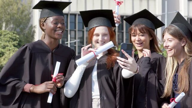 Four female graduates celebrating lifting phone initiating selfie as graduation CTA bar toggling