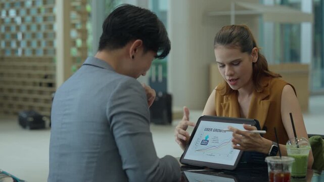 Business model marketing strategy ai tablet analytics meeting presentation growth with teamwork collaboration, two coworkers review data on tablet, office planning, chart guide, focused communication