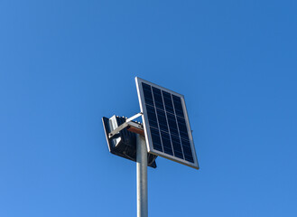Obraz premium Bright solar panel stands tall against clear blue sky in sustainable energy revolution.